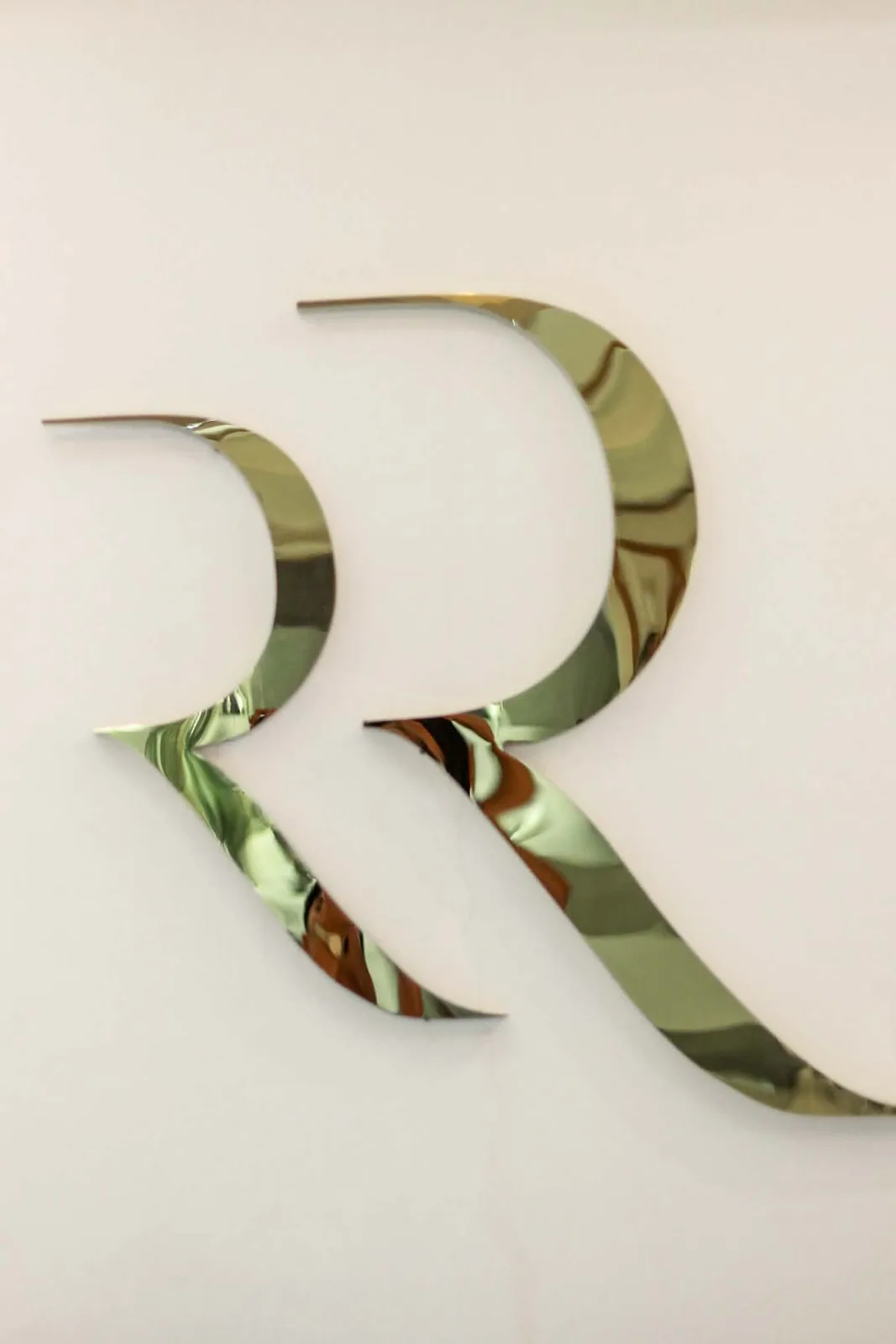 Rose Razzouk gold wall sign